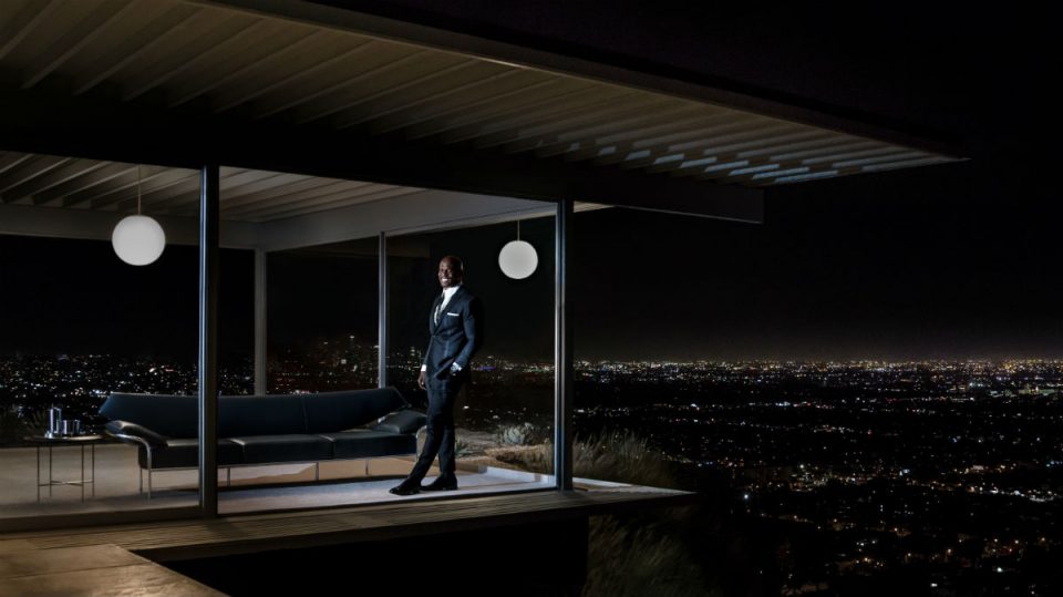 Image of a man standing in a window at night