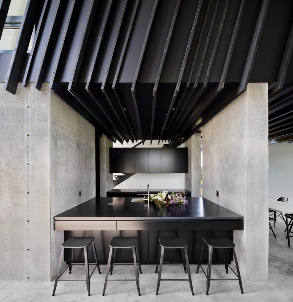 A concrete and charred wood kitchen