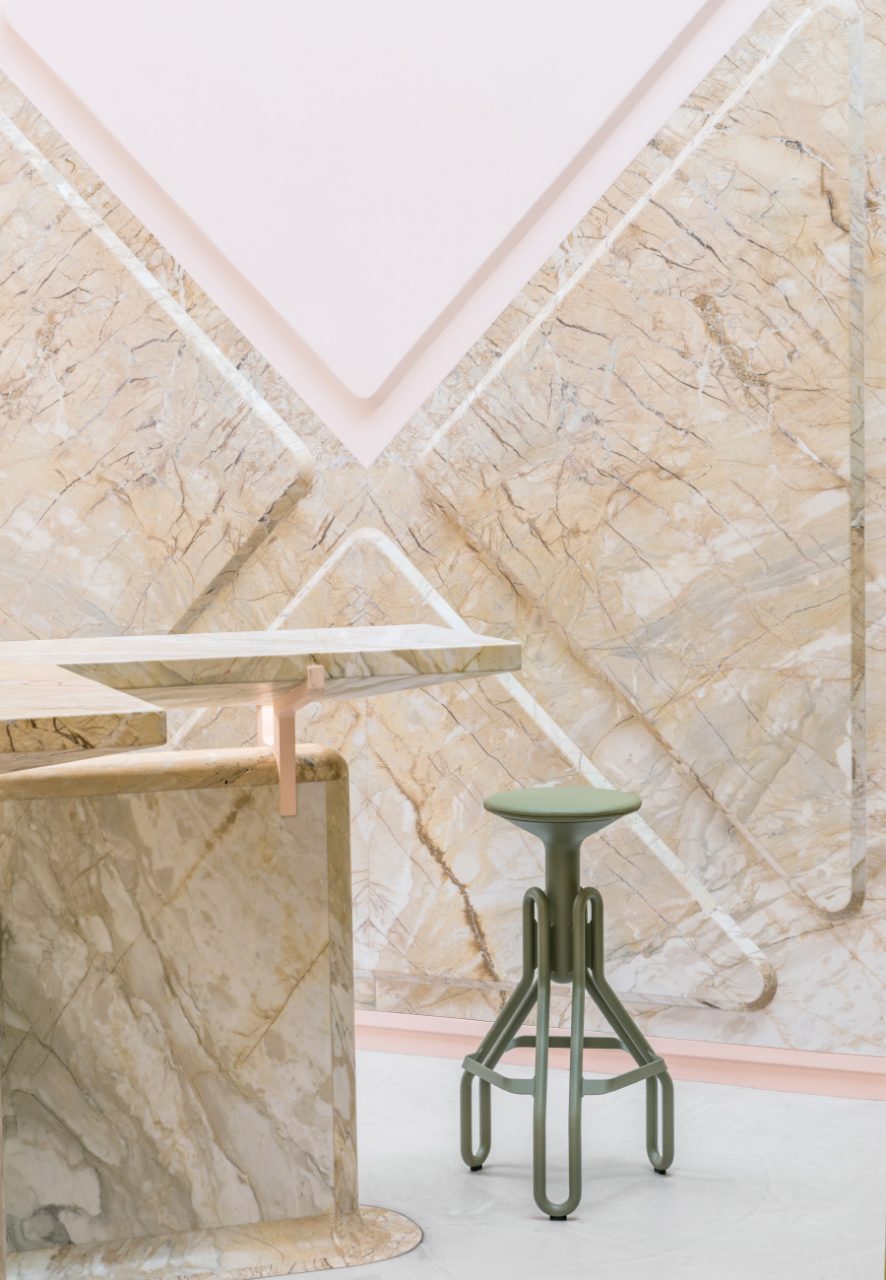 Close up view of a marble wall and green stool