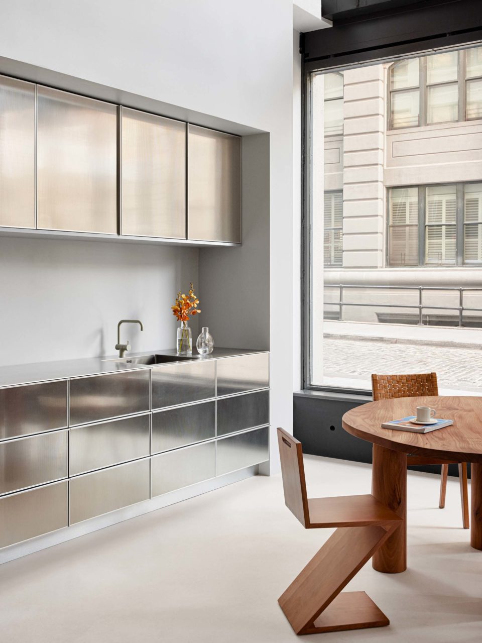 shiny metal cabinets and wood dining furniture