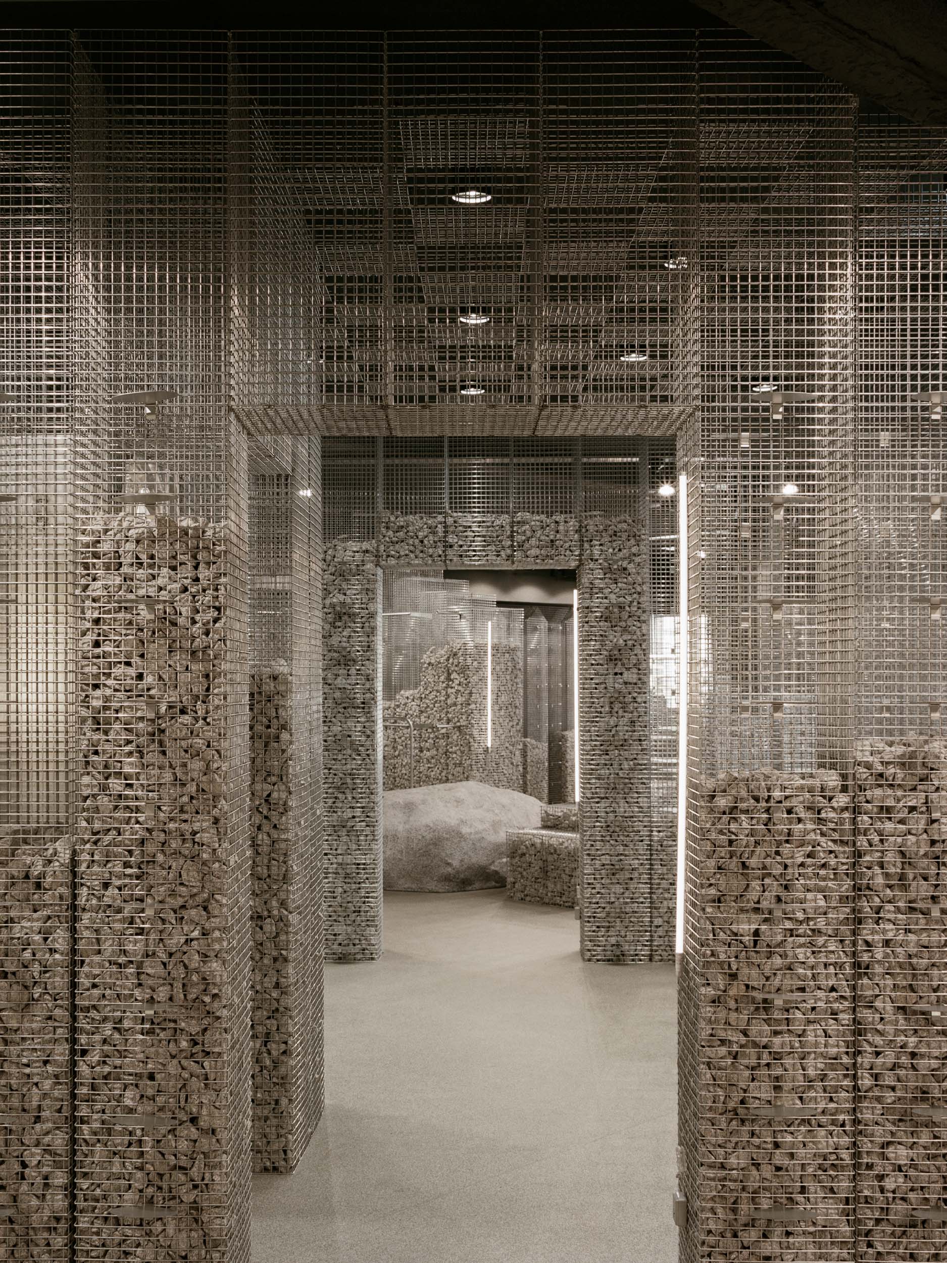 Structures of wire mesh create portals in a retail store in Portugal