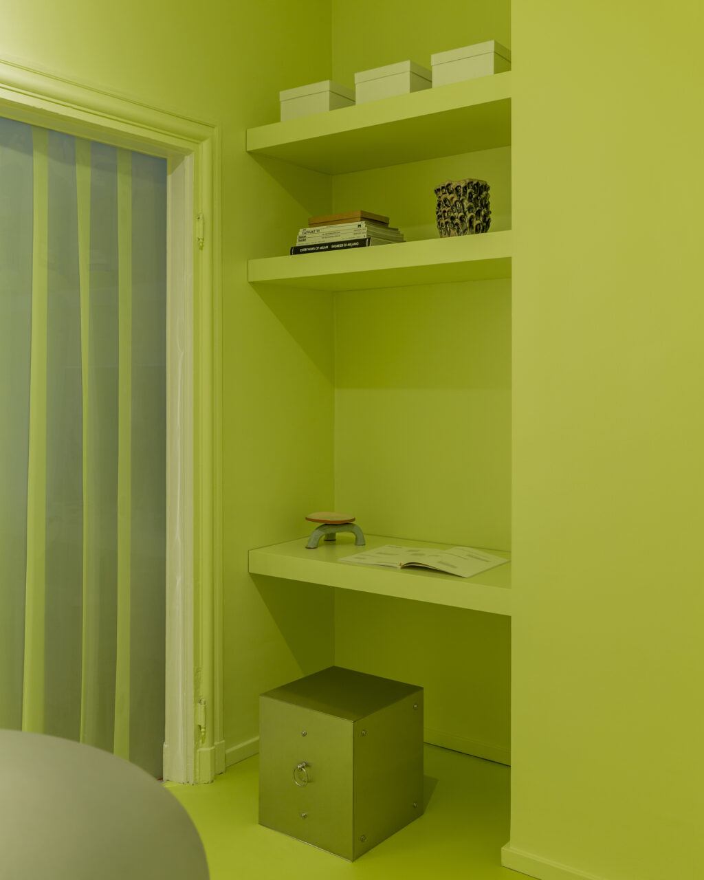 A room and its bookshelves are all acid green