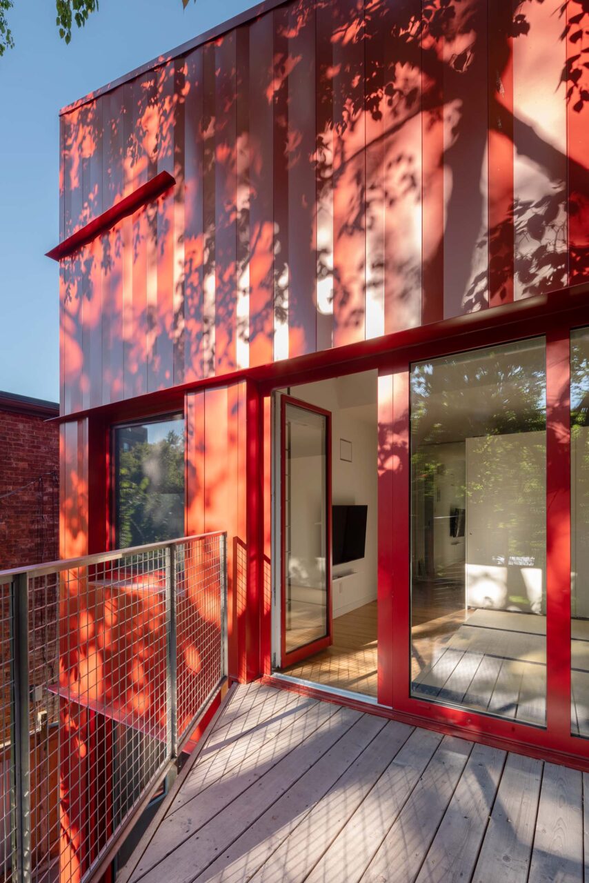 Red-coated steel frames the addition of the Toronto home