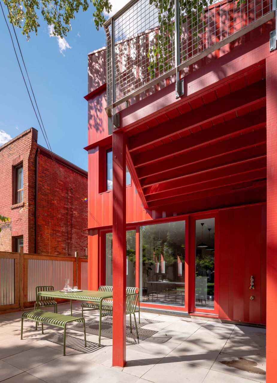 The red steel addition to the home provides an indoor-outdoor feeling
