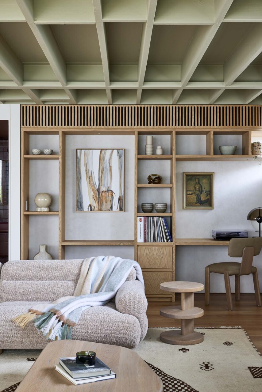 Green rafters are visible in a living room with a neutral color palette