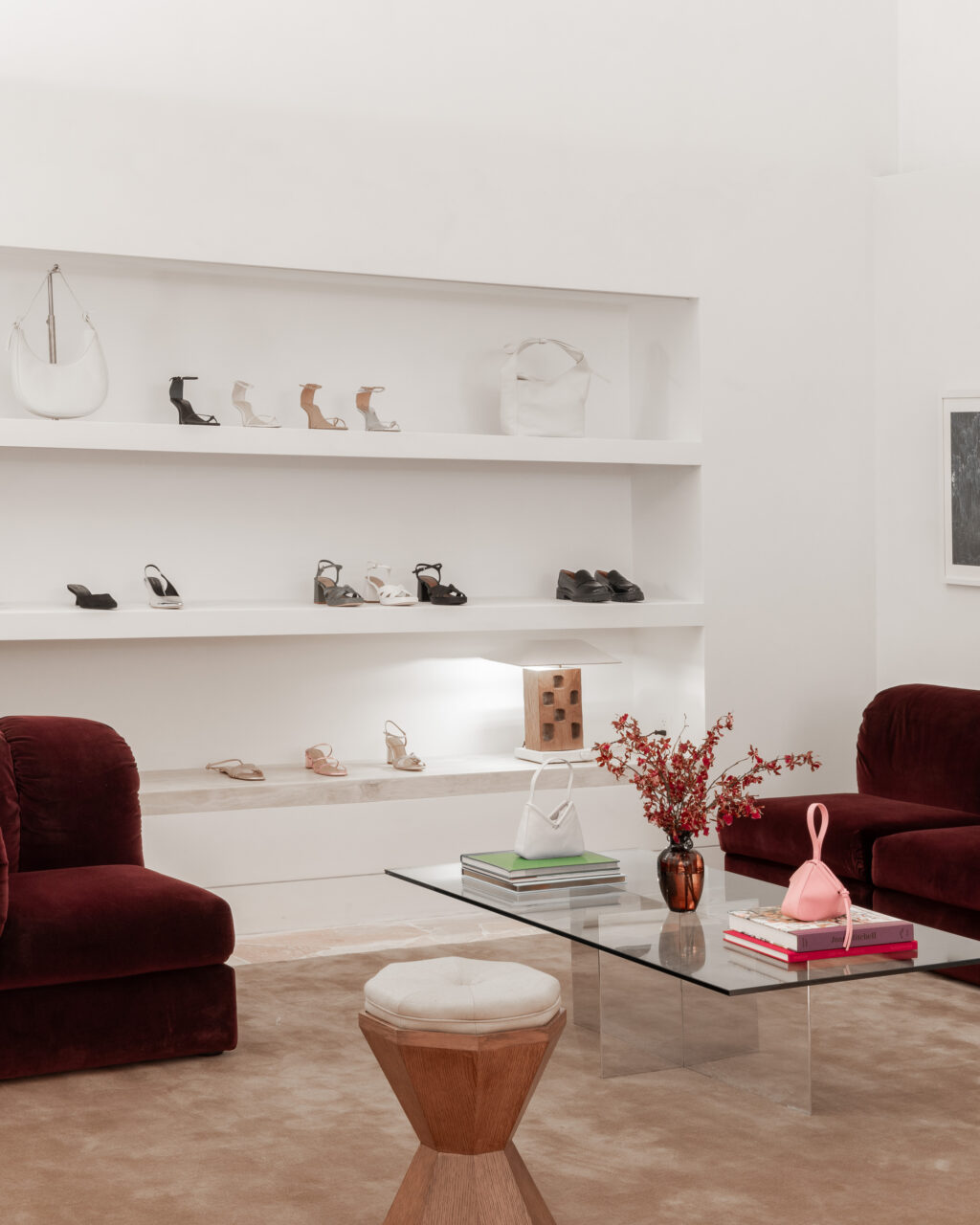 The shoe section of a store features furniture set up like a living room