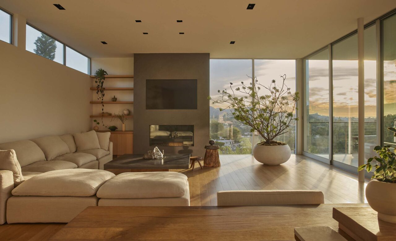 Natural materials and a neutral color palette form the living room of a house