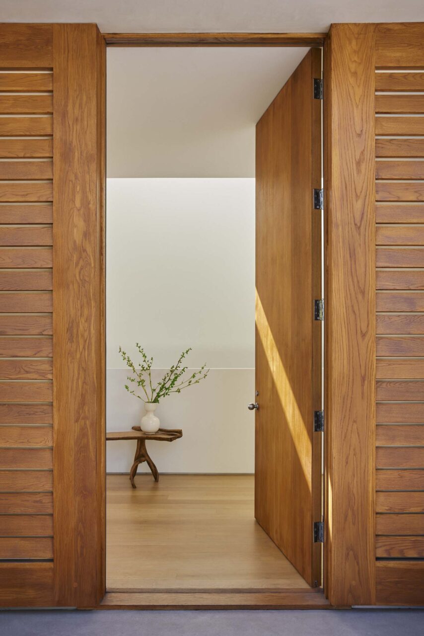 A wooden door provides entry into a tranquil, meditative space