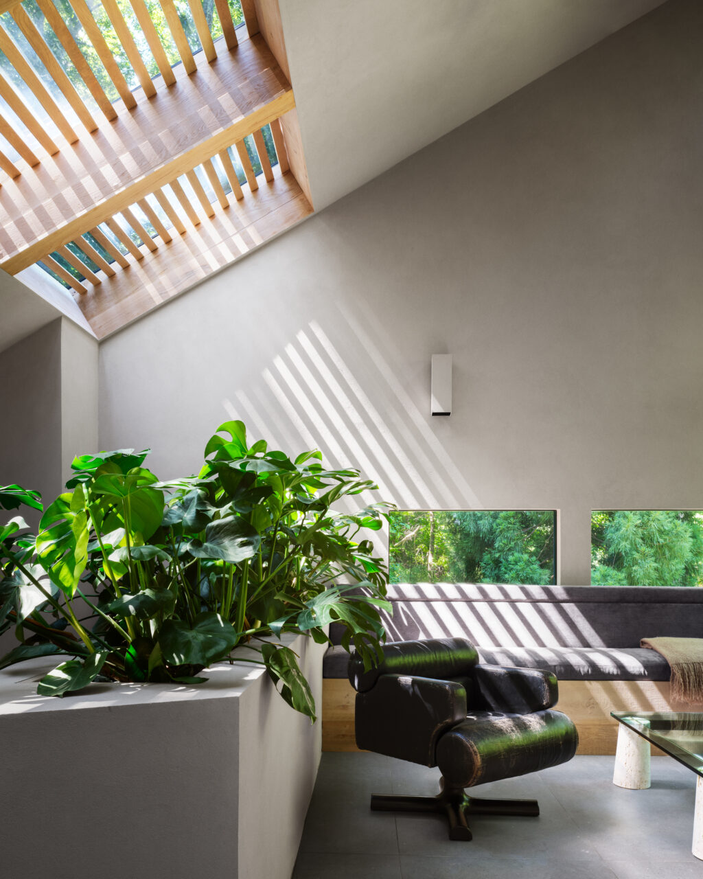 Light shines into a room via the skylight fitted with wooden slats