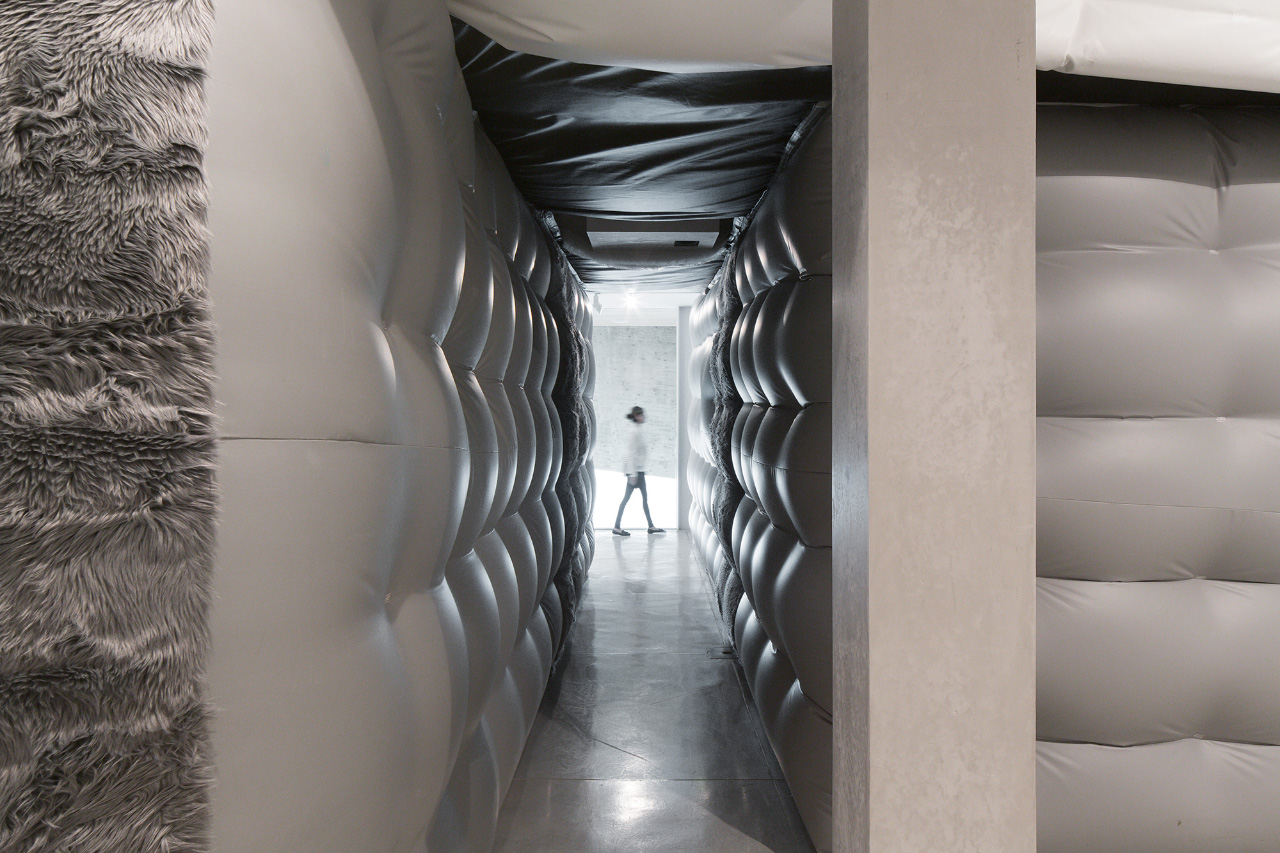 Person walking past an inflatable hallway