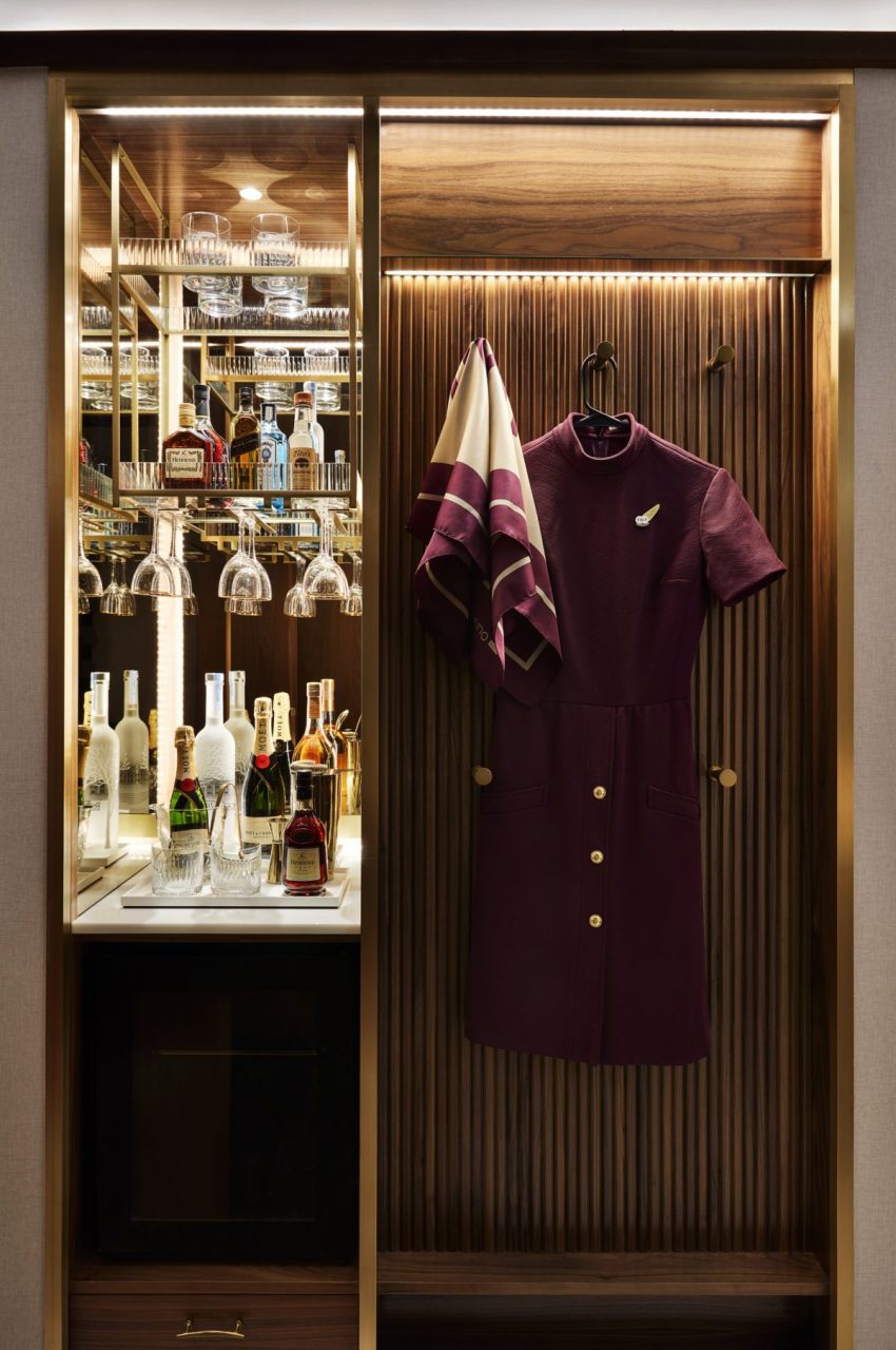 Up close image of closet and mini bar with bottles of alcohol and glasses