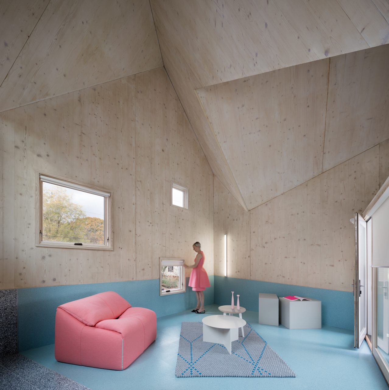 Image of Haus Gables living room with blue floor and pink furniture