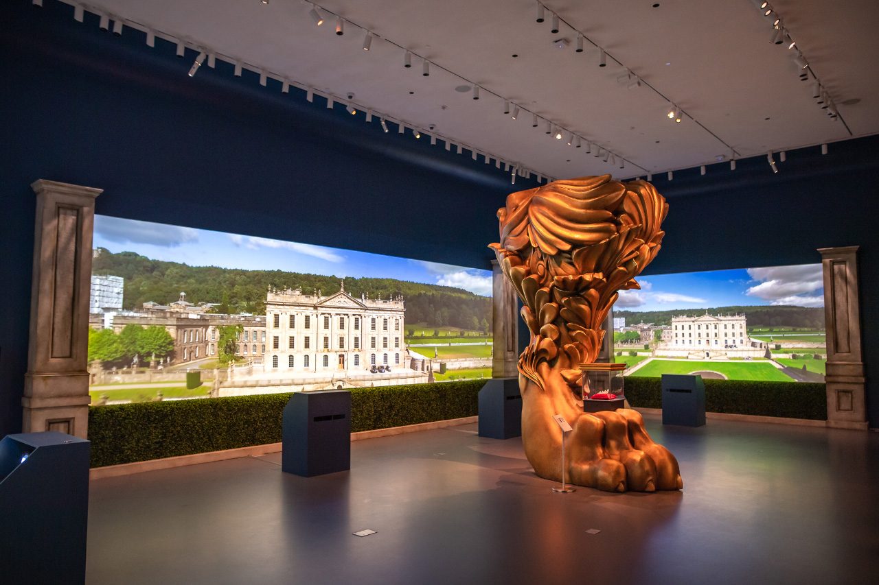 A 12-foot-tall lion's leg in the middle of a darkened gallery