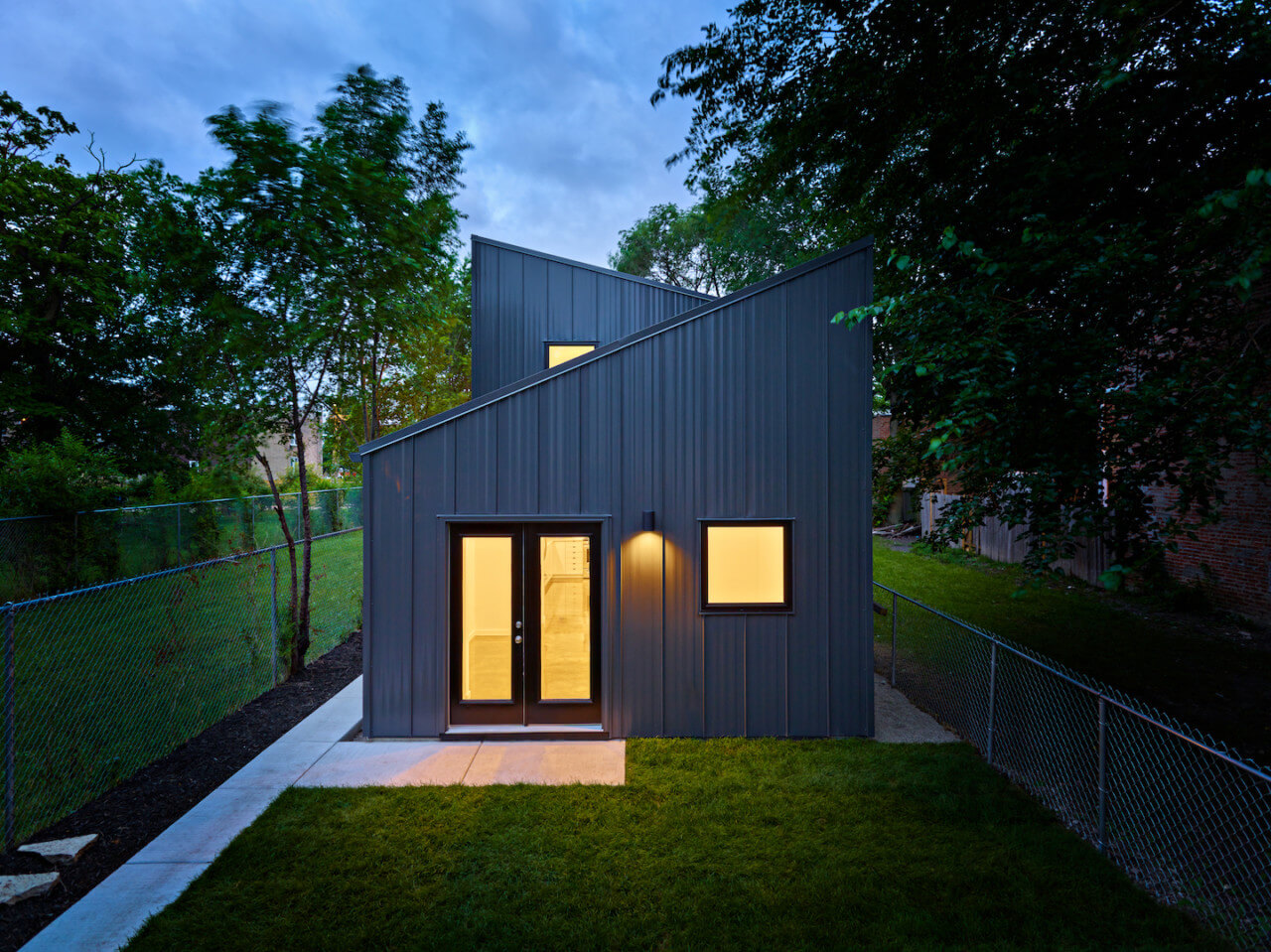 rear view of a narrow, metal-clad house on a chicago lot