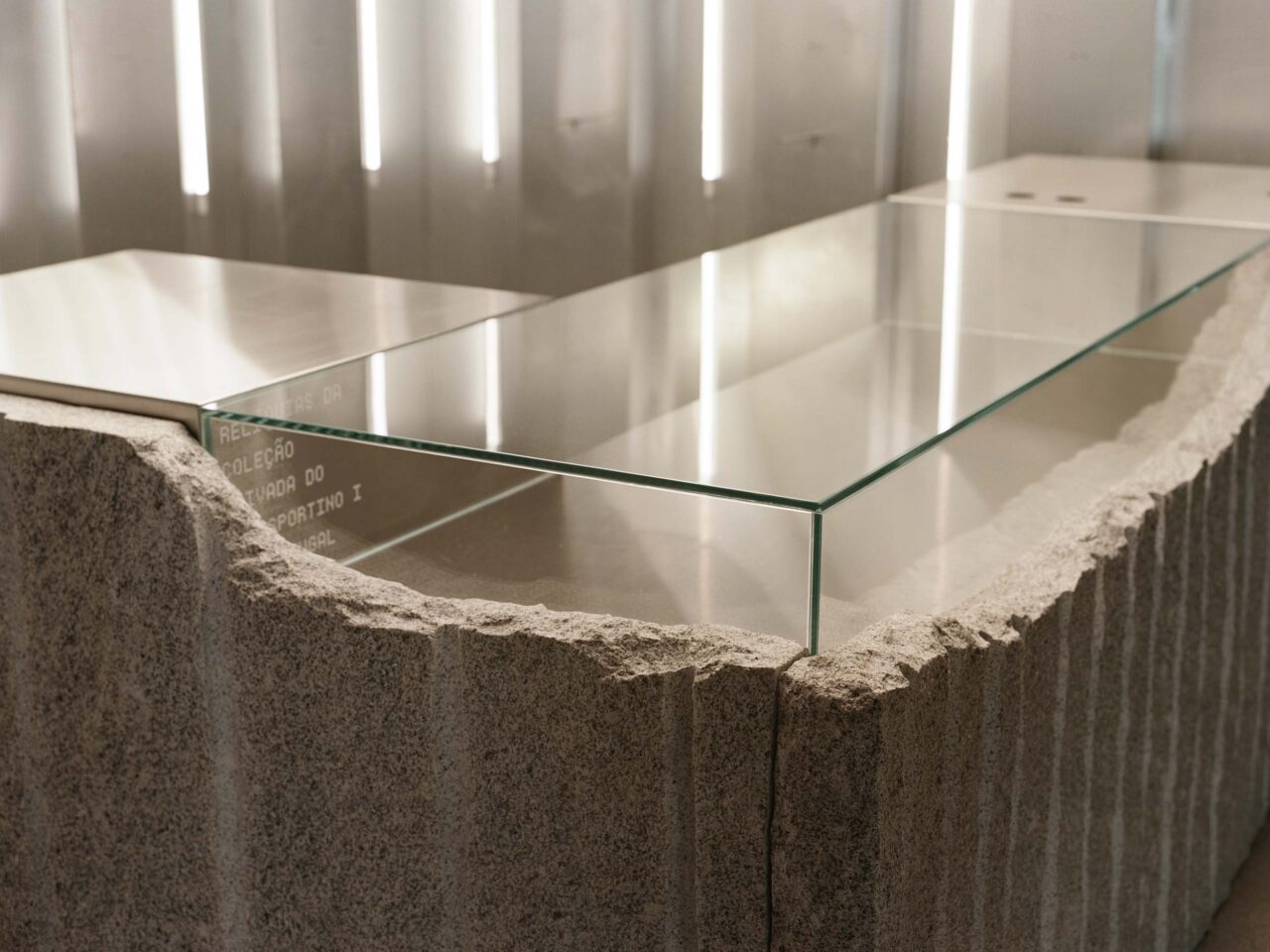 An imperfect stone counter from which a glass top emerges