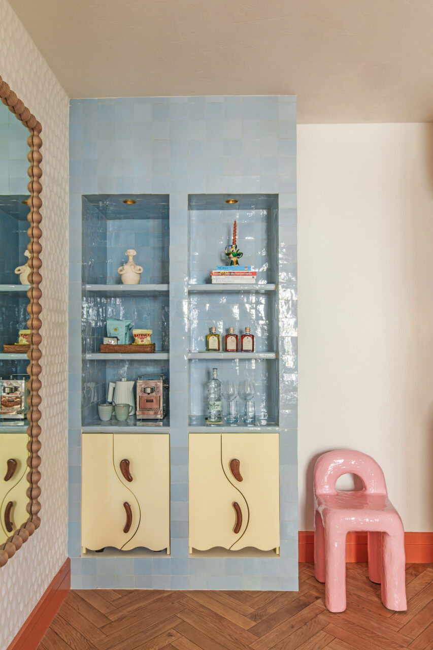 Blue shelving and a funky clay chair set the scene