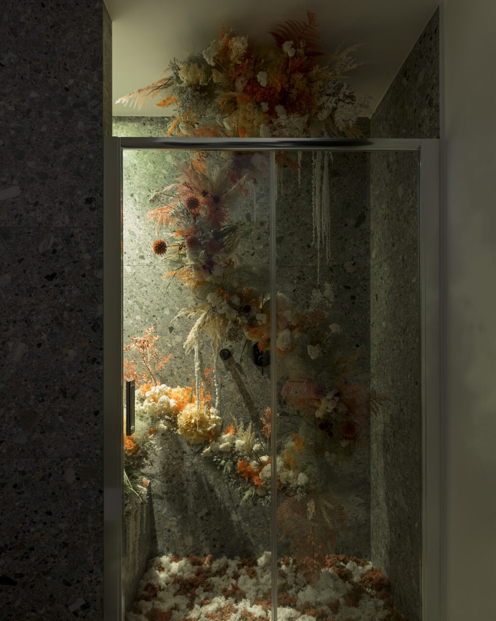 A floral installation in a bathroom shower stall