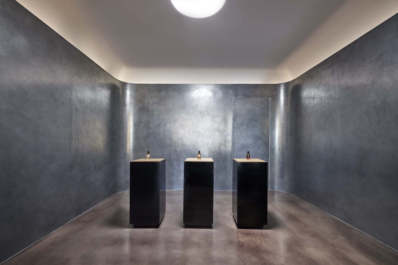 A room in the back of a store features a wall coated in metal alloys