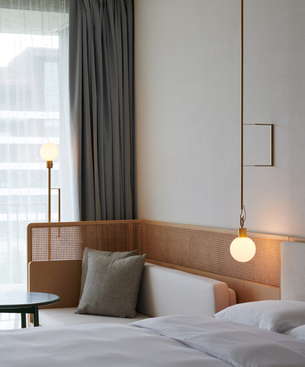 rattan headboard and bulbous light fixtures