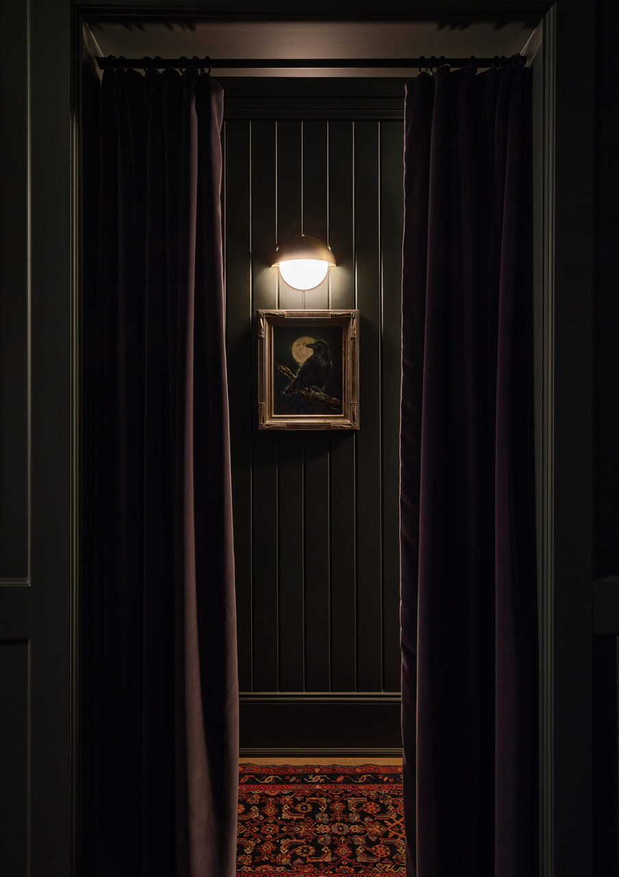 Velvet curtains part to reveal a dimly lit hallway at Lone Mountain Ranch