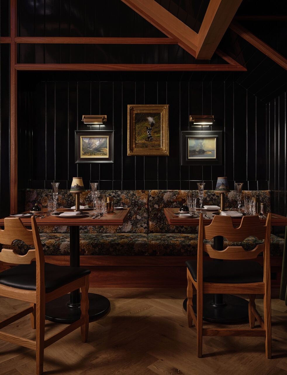 North 45 Projects designed a dark bar and restaurant with exposed rafters