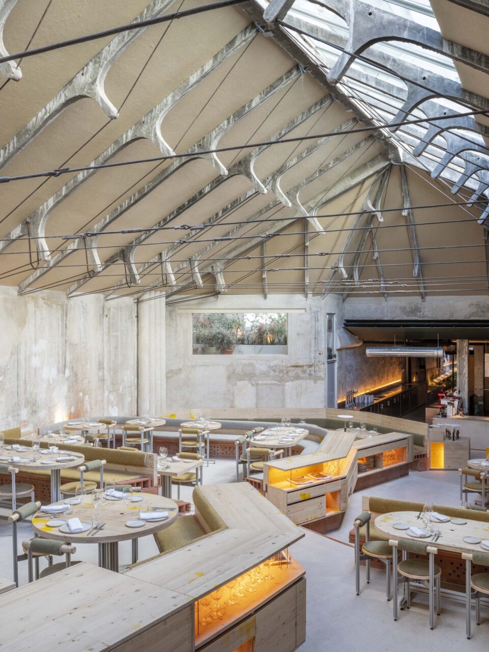 Steel cables line the concrete roof of a restaurant by selgascano