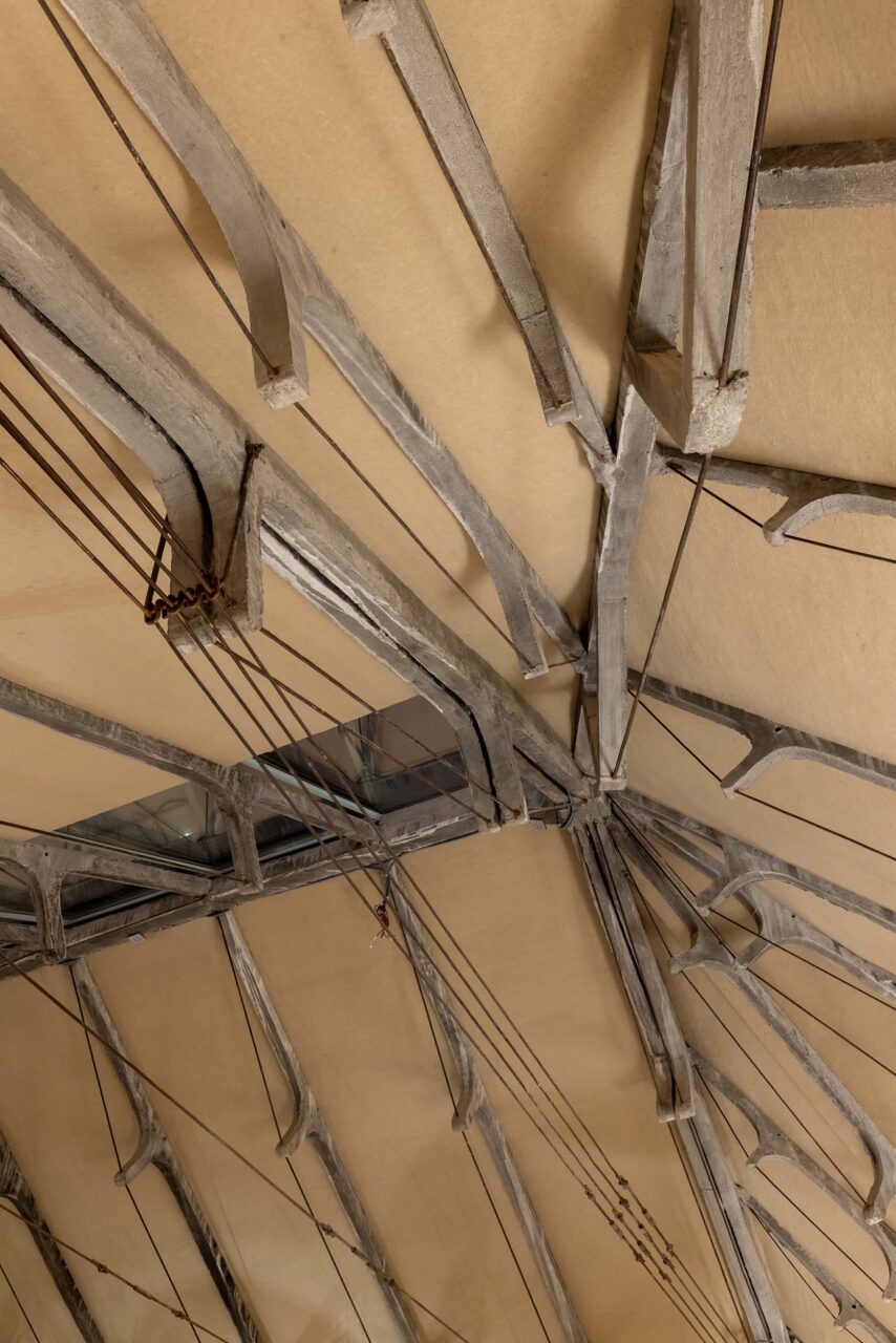 A close-up look at the ceiling of TRAMO where cement is held by steel rods