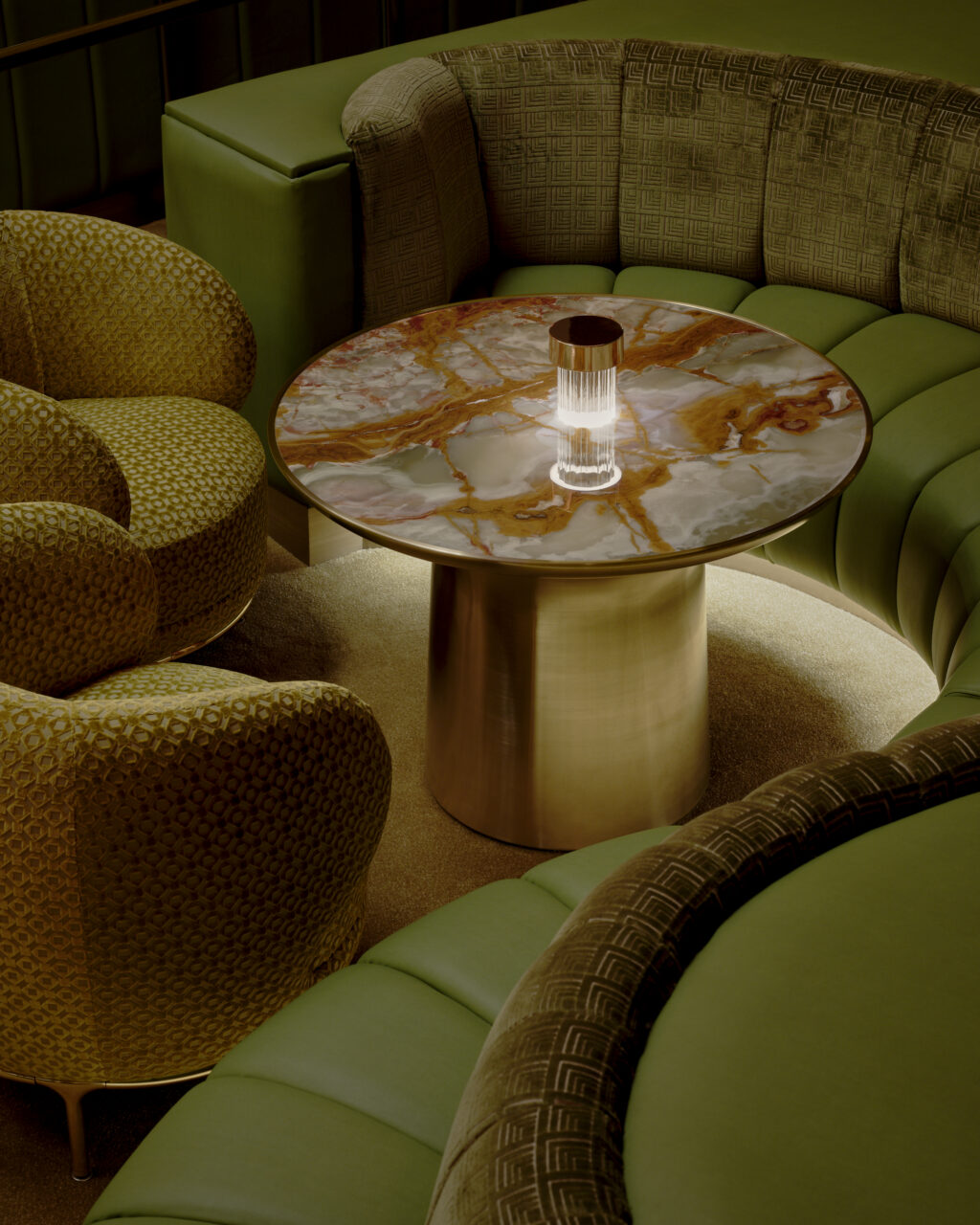 green sofa and stone table in The Pinky Ring