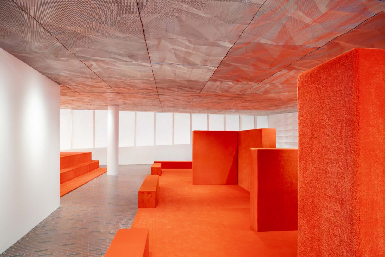 An orange stage and set pieces at Walker Art Center