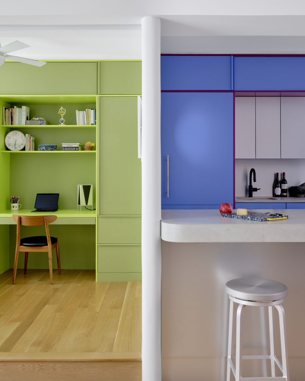 A green flex room lies next to a blue kitchen by Ideas of Order
