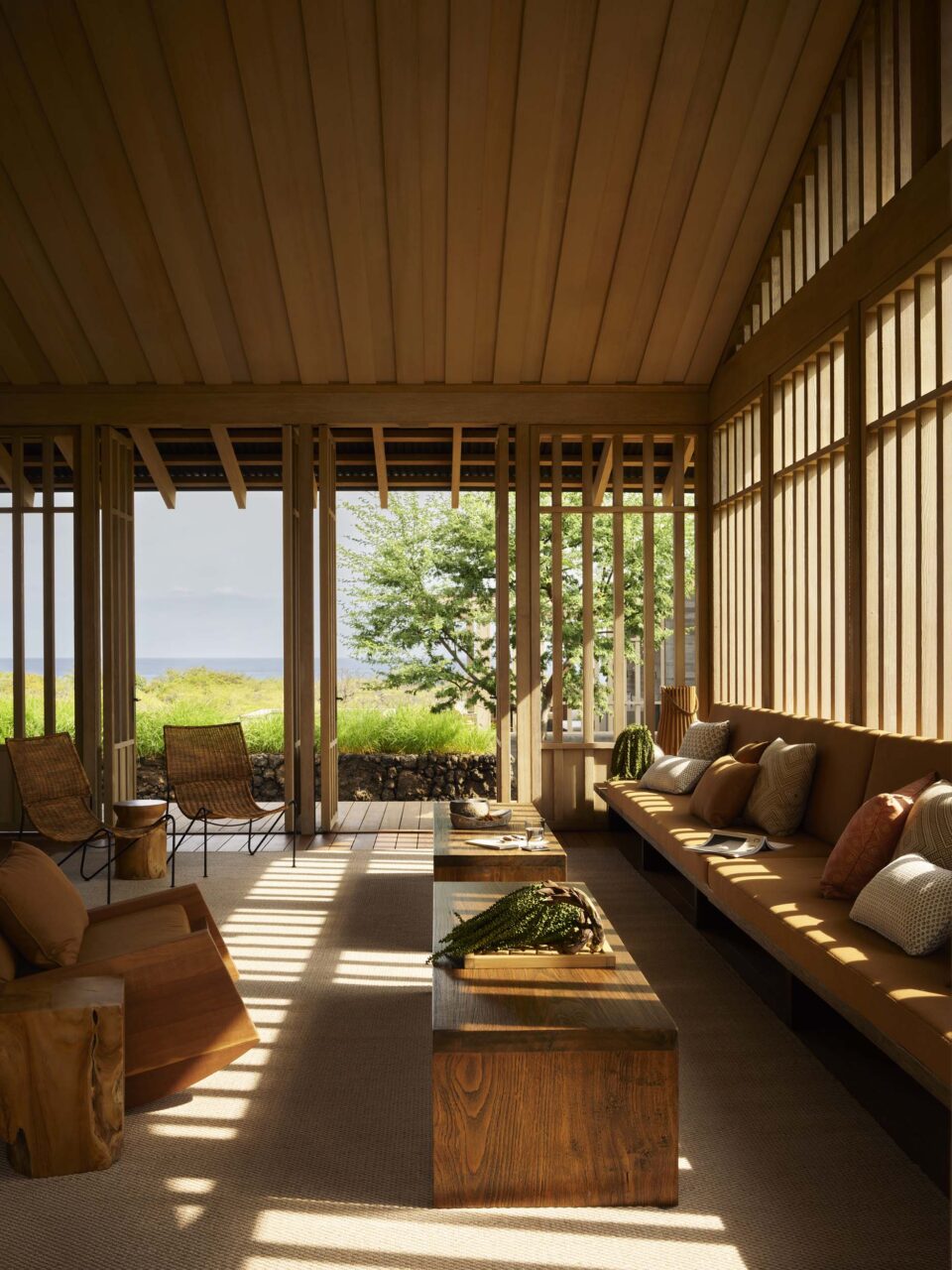 An open-air lanai makes for the living room designed by Walker Warner