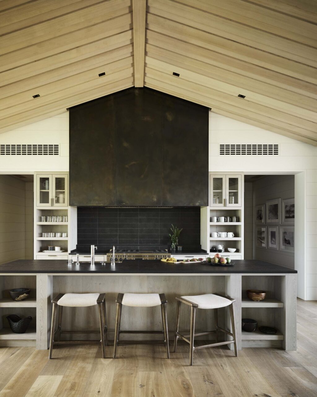 A steel kitchen falls under sloped, wooden roof at Hale Kiawe by Walker Warner