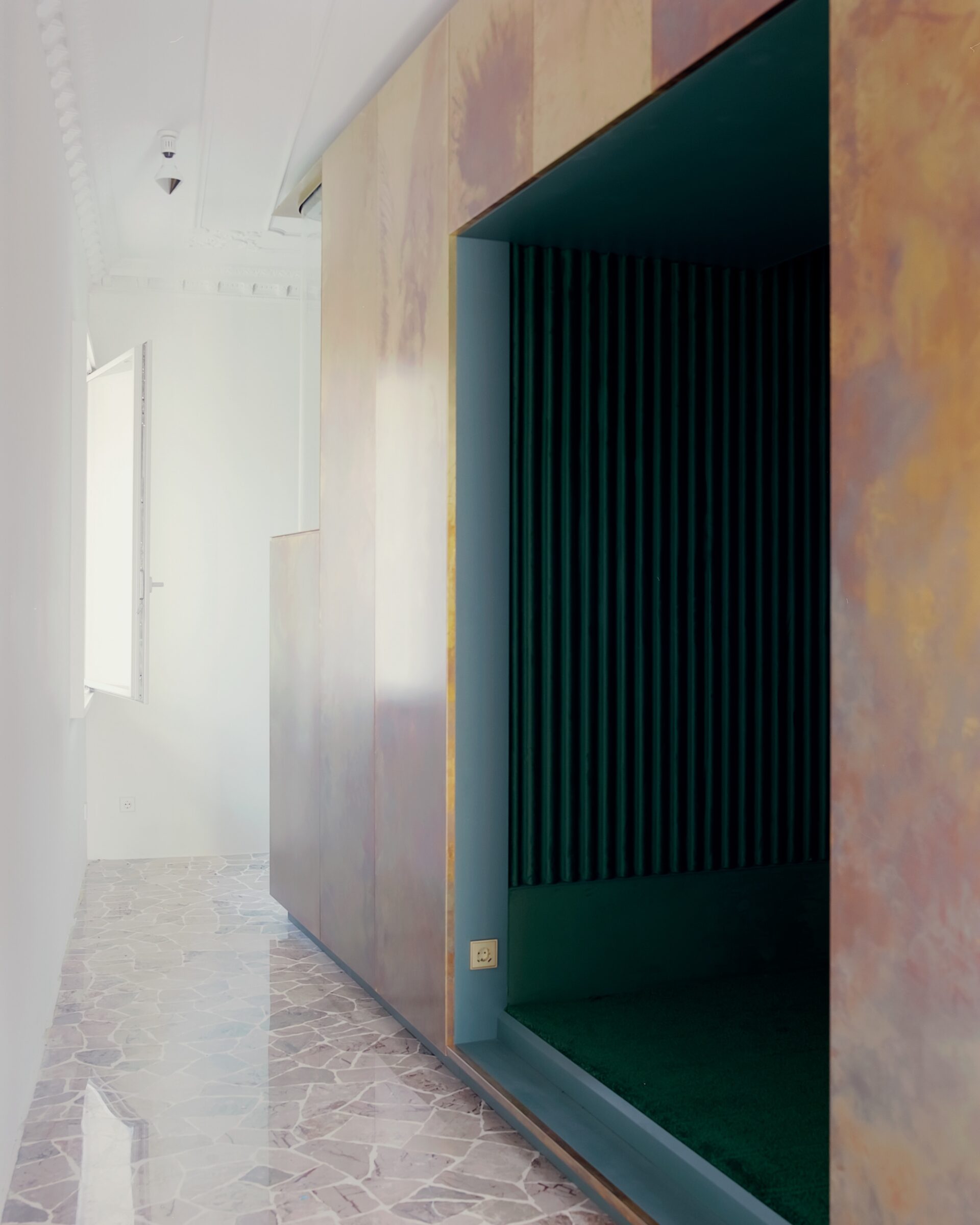 A brass volume inserted into an AMAA-designed apartment narrows into the corner window