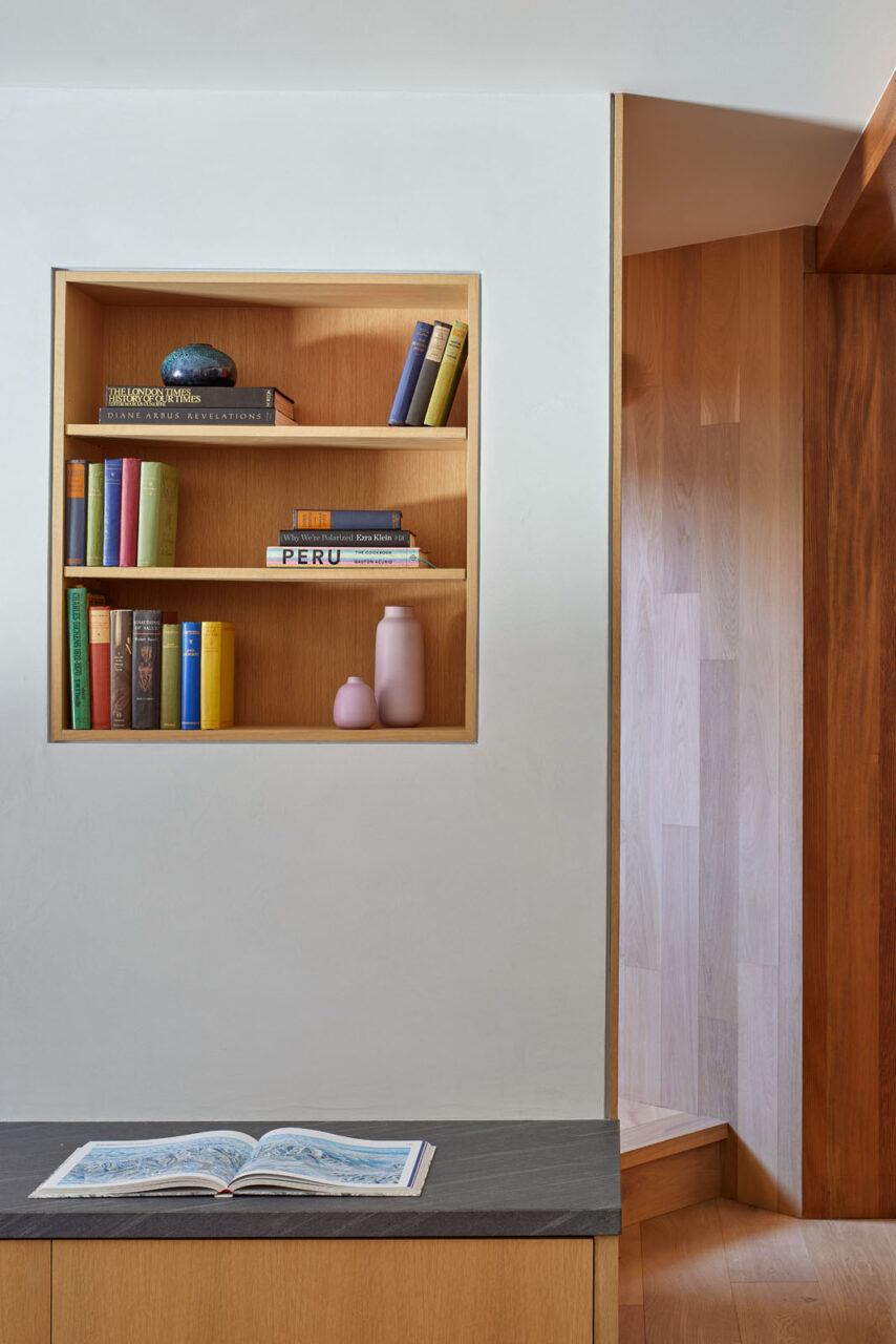 A wall contains a built-in oak shelf designed by Obata Noblin Office