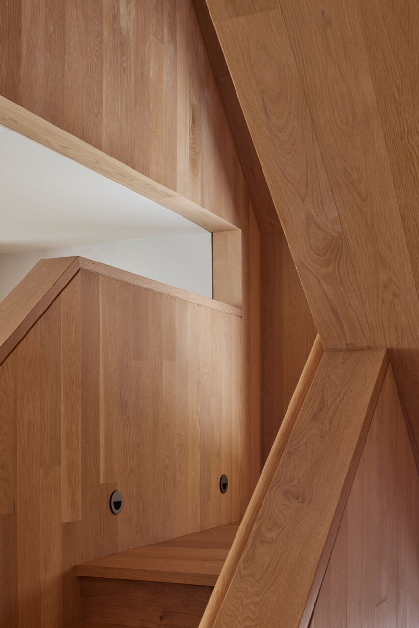 A close-up view of the wooden stairs at a 1970s ski house