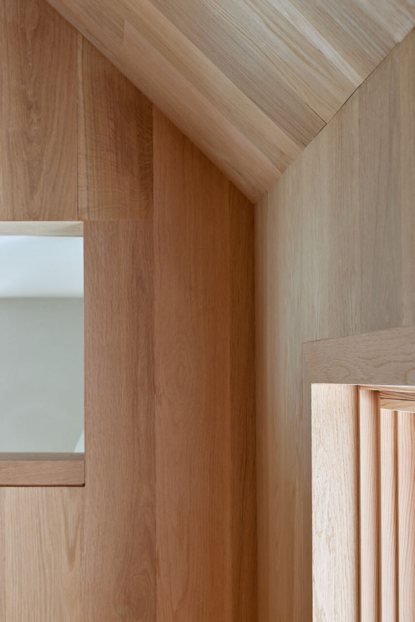 A close-up shot of a wall and sloped ceiling all in wood, designed by Obata Noblin Office