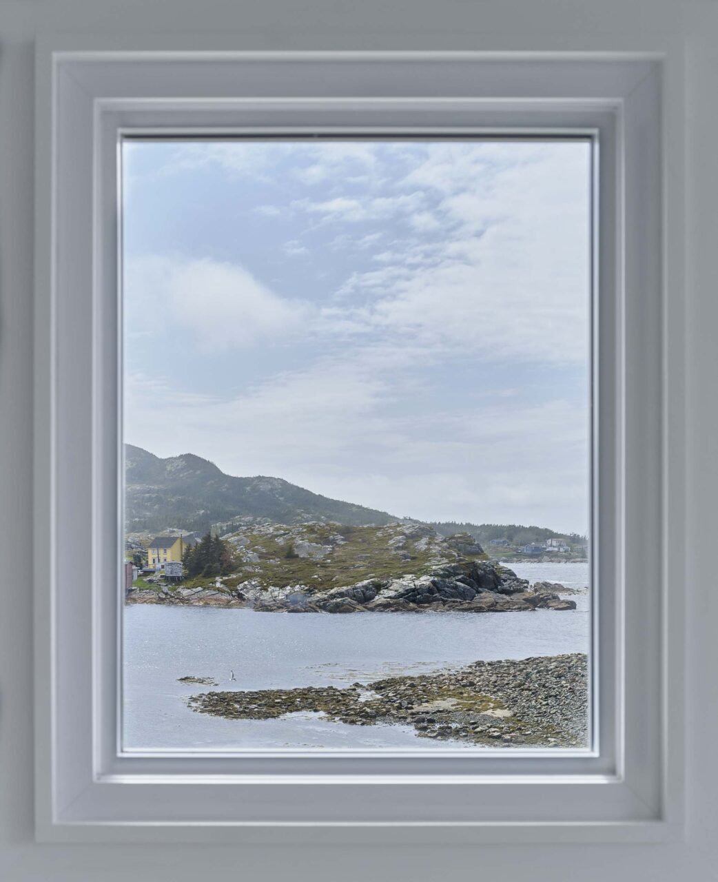 A window perfectly frames the coastal landscape of Salvage