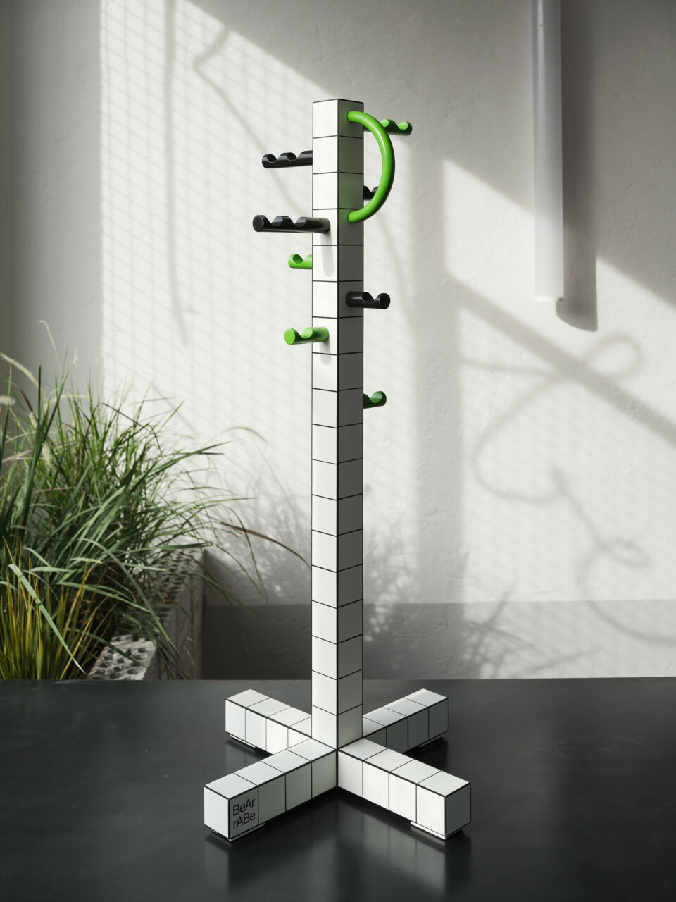 A tiled coatrack with electric green knobs was designed by Bear Architects