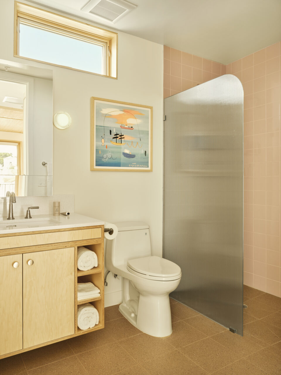 The bathroom is clad in soft pink tiles designed by SuperLA