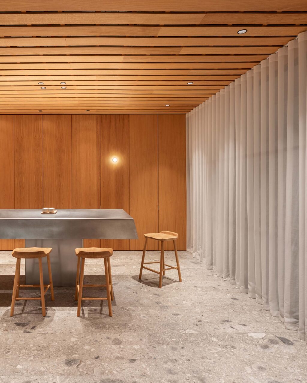 Ceppo floors, pleated curtains, and wood ceiling make up WatchHouse by EBBA