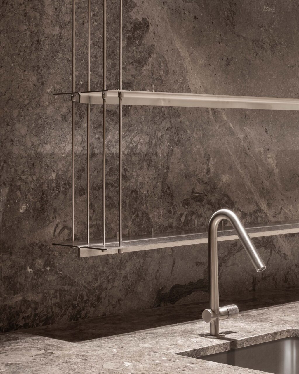 A steel faucet with steel shelves behind it, designed by EBBA