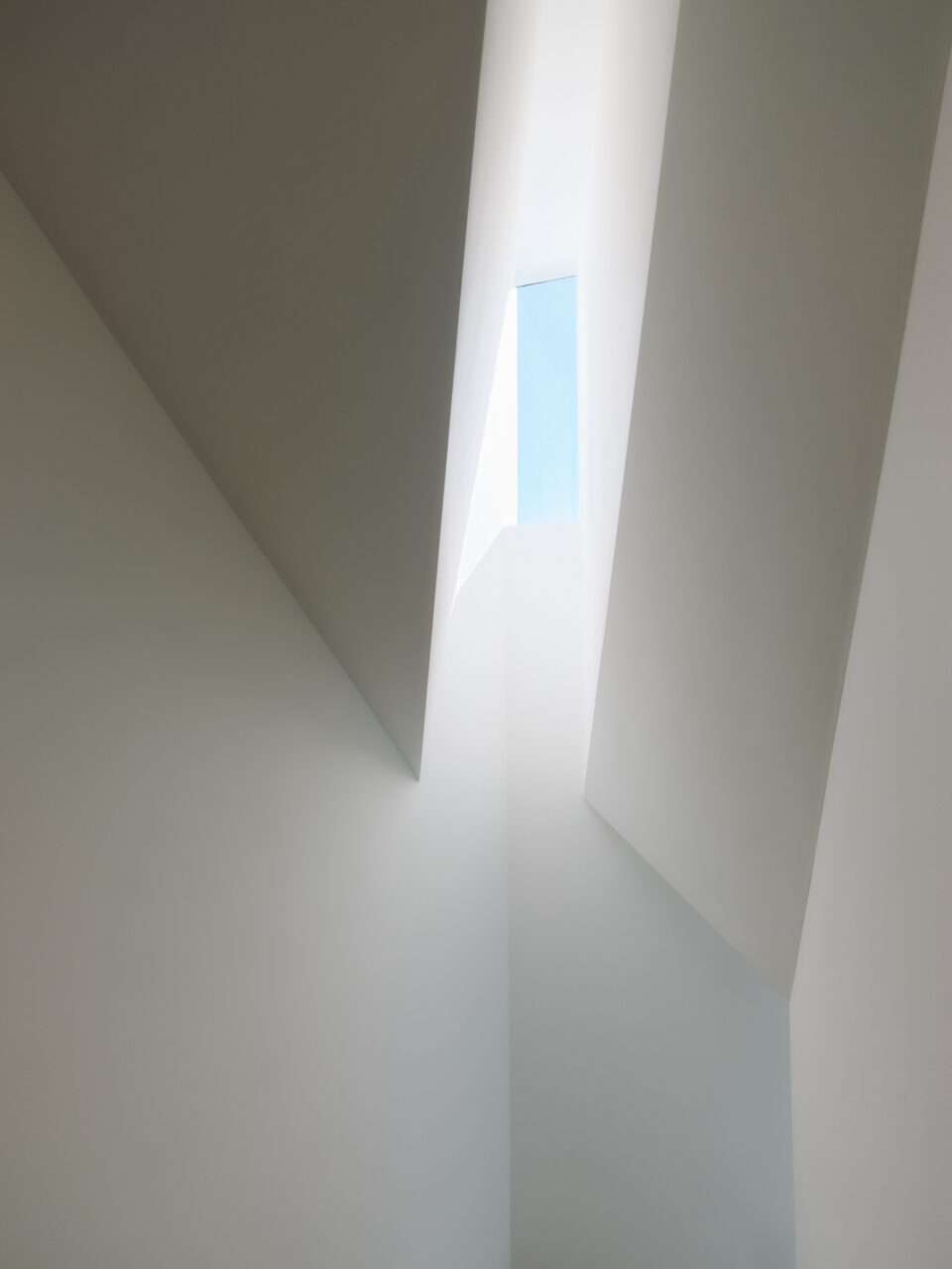 A skylight shines light down a crack between two volumes in Capturing Light