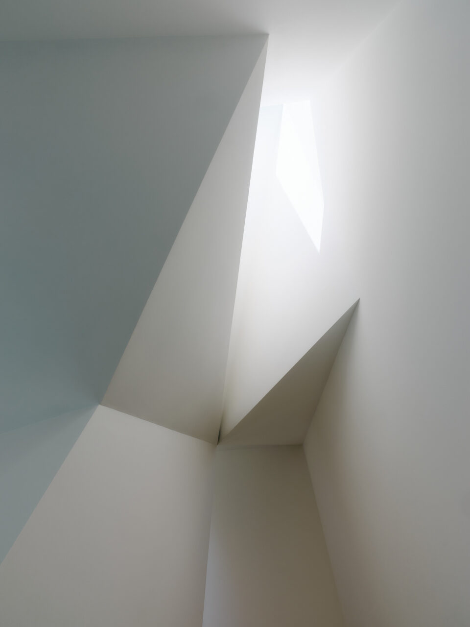 Clerestory window with cut-out planes on the wall by Min Design