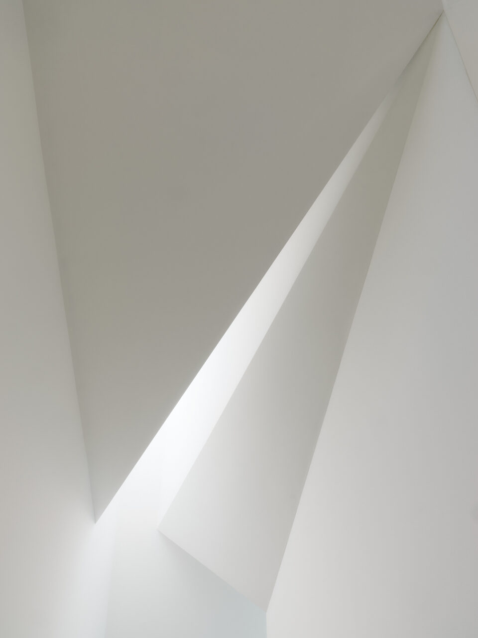 A ceiling by Min Design with places and voids to sculpt light