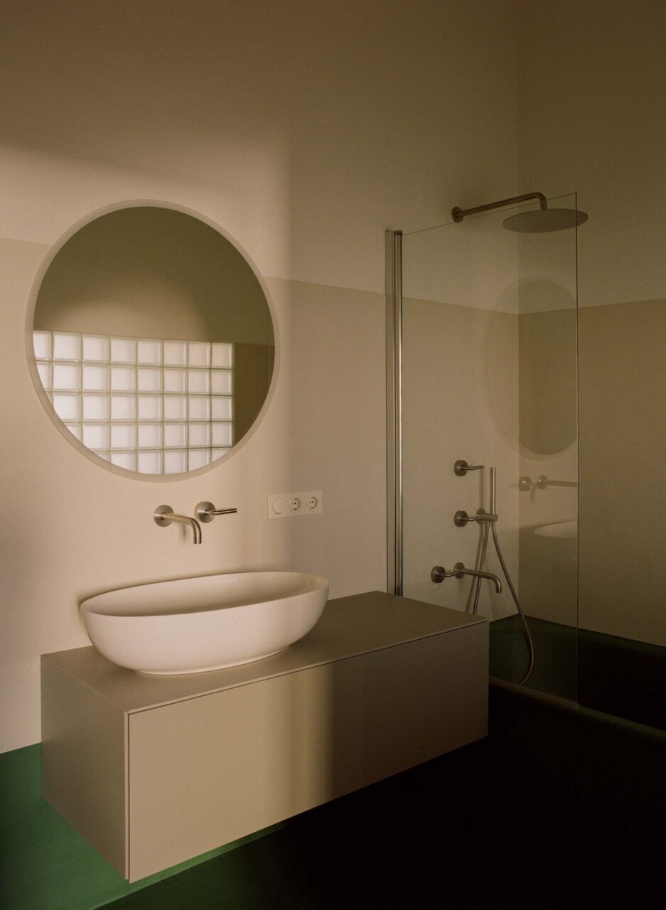 A green and white bathroom by Some Place Studio