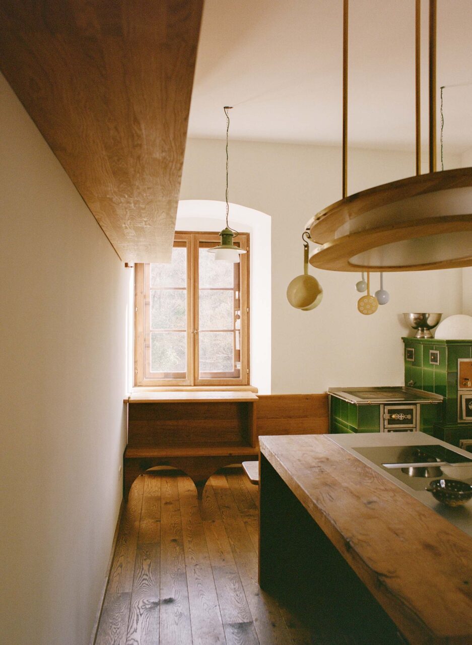 A bare kitchen with green stove at a medieval castle in Vienna