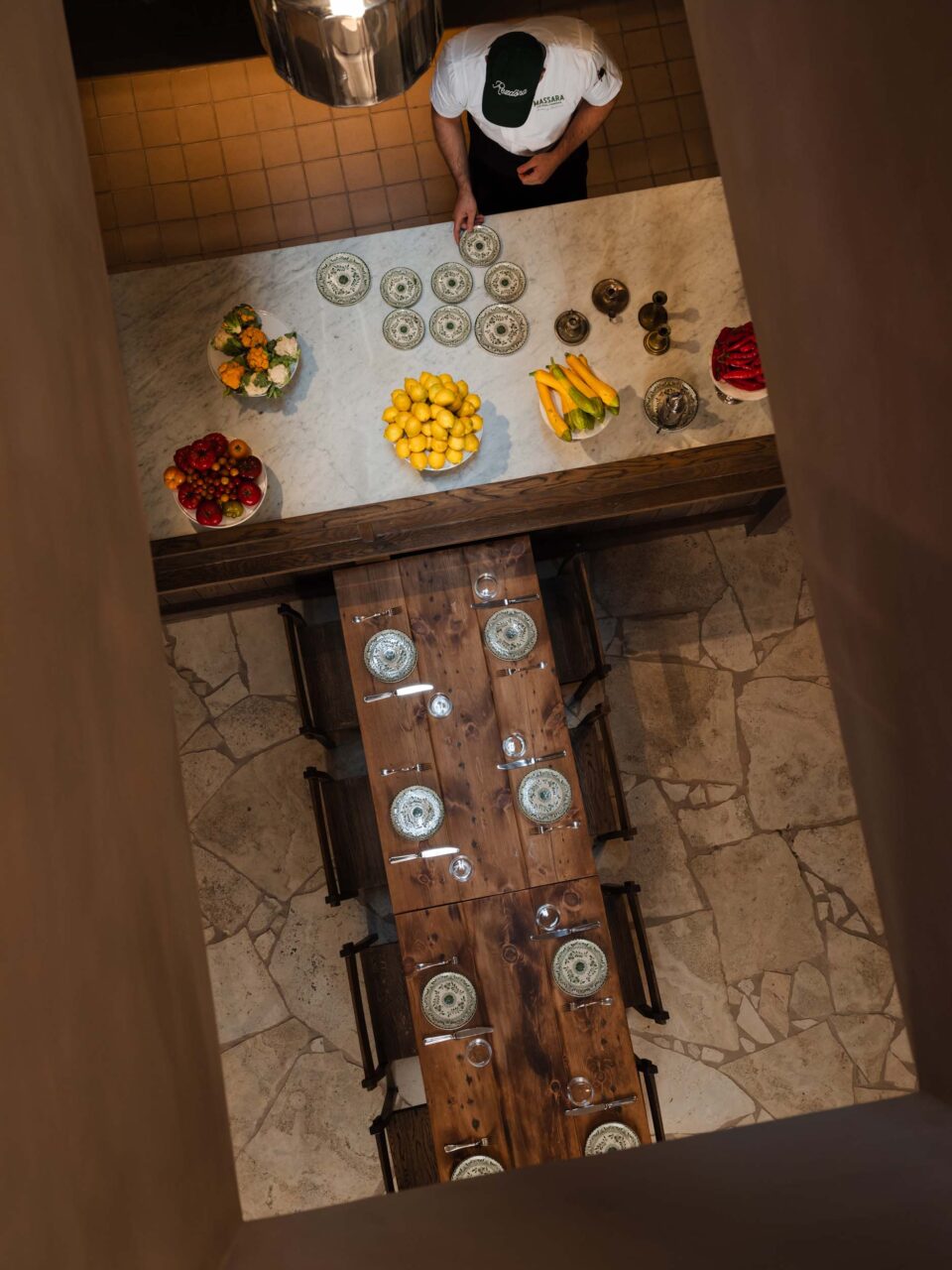 A rectangular opening looks onto the dining room and pizza-making of Massara