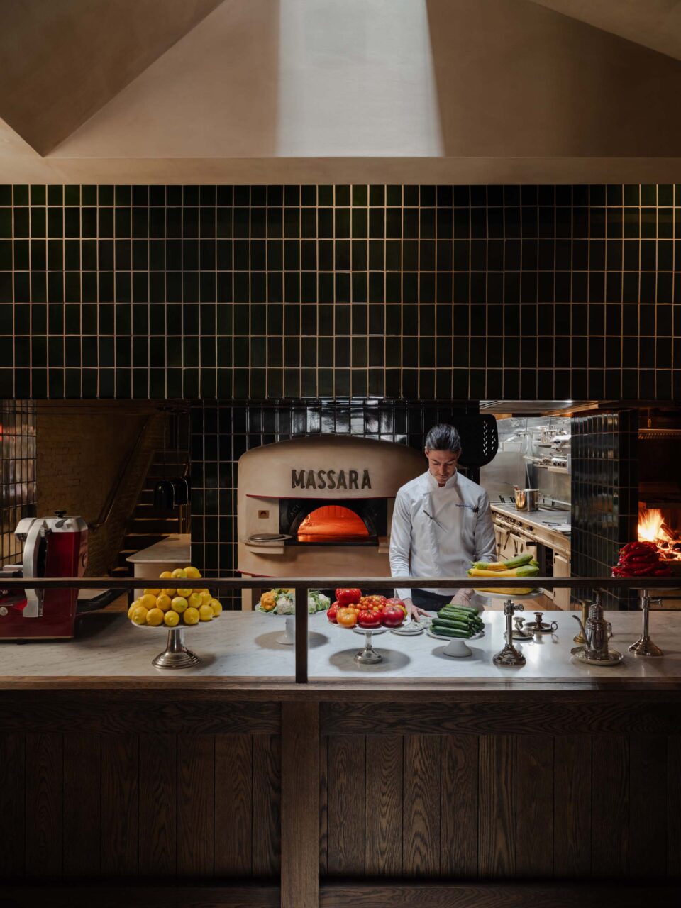 The tiled pizza oven of an restaurant by Sarah Carpenter & Studio