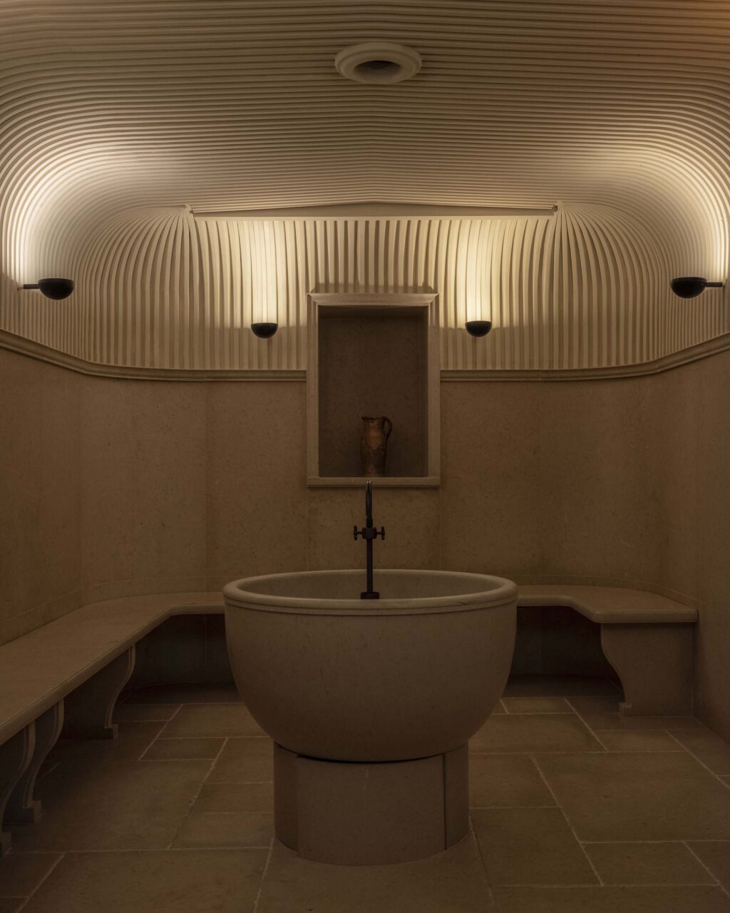 A bathhouse at a hotel with fluted plaster vaults