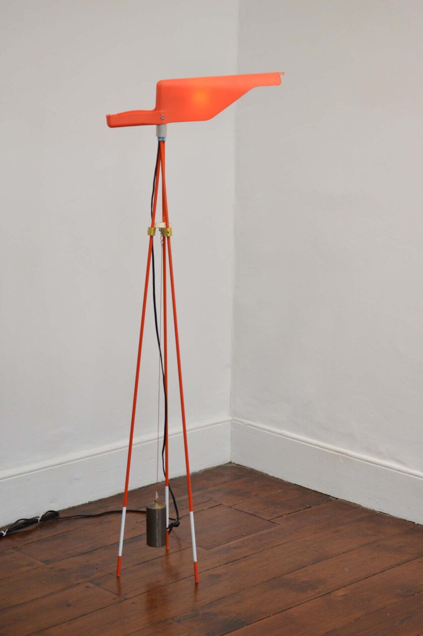 David Weeks designed a floor lamp made of fiberglass driveway markers, gutter leaf scoop, and a dead weight pendulum